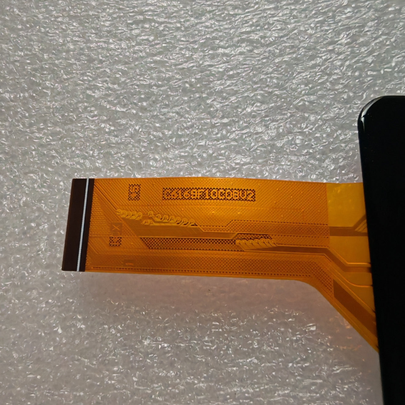 Close-up view of the internal flex cable for C6169F10C0BV2 to verify the connector pins and hardware version