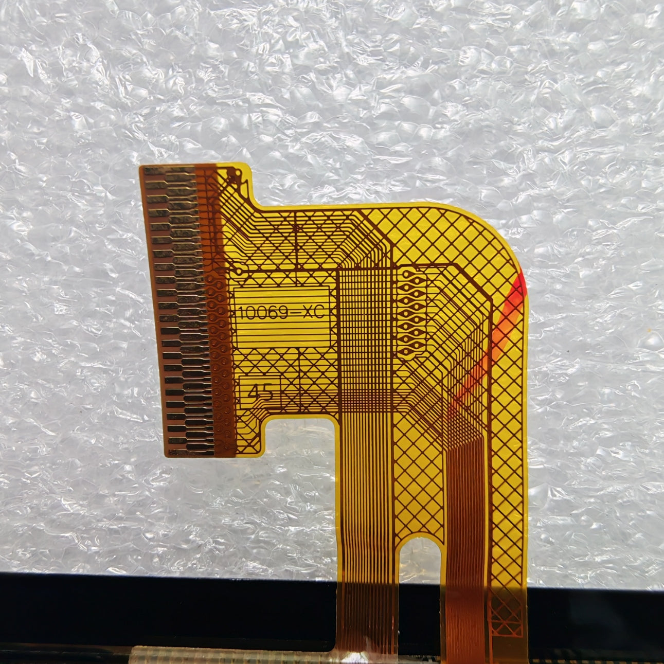 Close-up view of the internal flex cable showing codes JX-101PG1042-B0 and 10069-XC to verify connector pins
