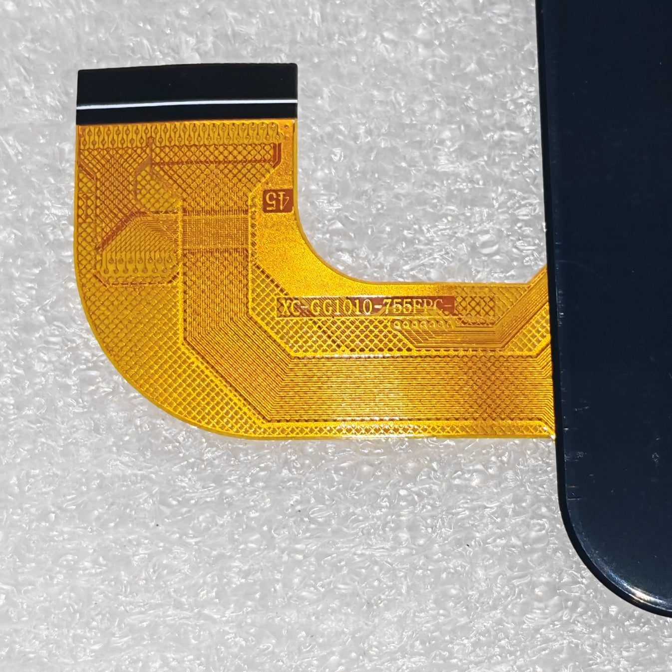 Close-up view of the internal flex cable showing the XC-GG1010-755FPC-A1 code to verify connector pins and hardware version