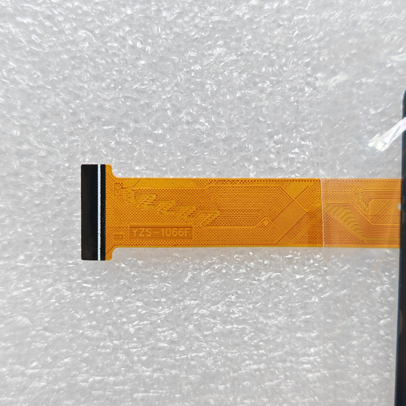 Close-up view of the internal flex cable for YZS-1066E to verify the connector pins and hardware code
